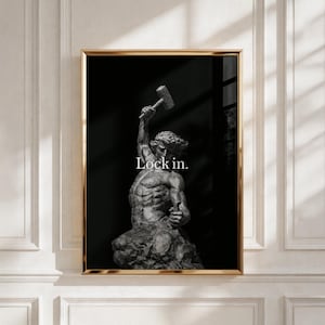 Könnte beinhalten: Ein gerahmter Wandkunstdruck mit einer monochromen Skulptur einer muskulösen Figur, die einen Hammer über den Kopf hebt. Die Figur ist vor einem einfarbigen schwarzen Hintergrund platziert, mit dem weißen Text Lock in. über dem Torso.