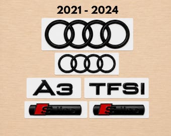 Könnte beinhalten: Ein Set schwarzer Autoembleme für Modelle von 2021-2024, bestehend aus zwei Audi-Vier-Ringe-Logos, einem A3-Schriftzug, einem TFSI-Schriftzug und zwei S-line-Emblemen mit roten und schwarzen Akzenten auf weißen, rechteckigen Trägerfolien.