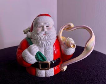 Tetera de cerámica vintage de los años 90 pintada a mano con diseño de Papá Noel y juguetes, modelo HollyTree, en caja.