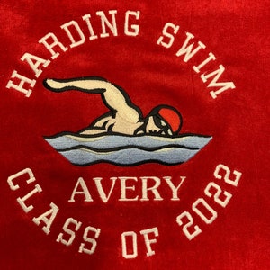 May include: Red fabric with white embroidered text and a swimmer graphic. The text reads "HARDING SWIM", "AVERY", and "CLASS OF 2022". The swimmer is in the water, wearing a red swim cap.