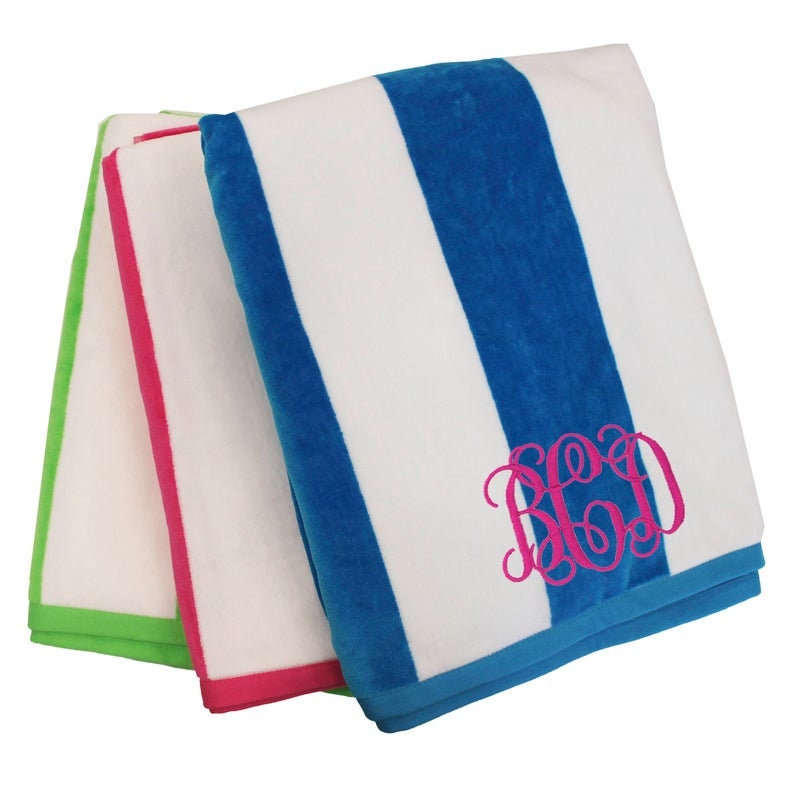May include: Three folded beach towels in white with colored stripes and trim. One towel has blue stripes and a pink monogram. The other two towels have green and pink trim.
