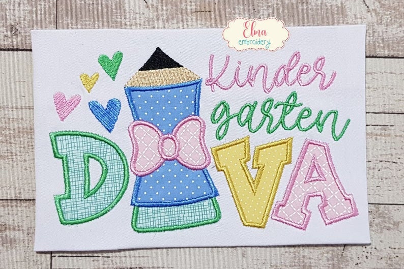 May include: Embroidered design featuring a pencil, hearts, and the words "Kindergarten Diva." The pencil is blue with a pink bow. The letters are green, yellow, and pink. The design is on a white background.