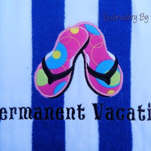 May include: A blue and white striped beach towel with embroidered pink flip-flops. The flip-flops have black straps and colorful accents. The words "Permanent Vacation" are embroidered below the flip-flops.