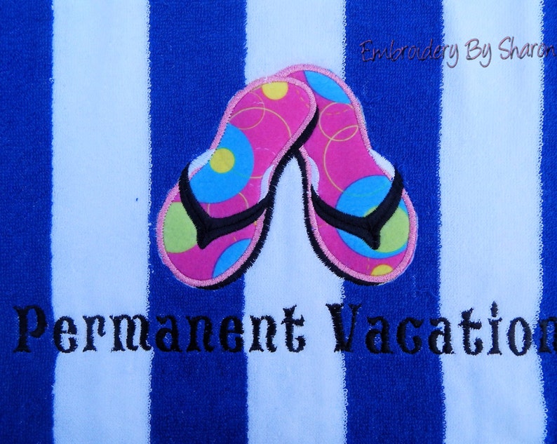 May include: A blue and white striped beach towel with embroidered pink flip-flops. The flip-flops have black straps and colorful accents. The words "Permanent Vacation" are embroidered below the flip-flops.