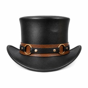 May include: A black top hat featuring a wide, flat crown and a curved brim. A decorative band wraps around the base, consisting of a brown leather-like strap layered with a black strap, two gold-toned metal rings, and small gold-toned rivets.