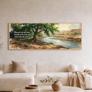 May include: A rectangular wall art print featuring a landscape painting of a large tree with exposed roots beside a flowing river and distant hills. The text "Blessed is the man that trusteth in the Lord, and whose hope the Lord is. Jeremiah 17:7" is printed on the left side.
