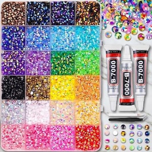 May include: A rectangular storage container with twenty-eight compartments filled with small, multi-colored round rhinestones. Included are two tubes of B-7000 adhesive, a white wax pencil, and a black metal tweezer tool for craft applications.