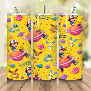 May include: A cylindrical stainless steel tumbler with a straw, featuring a bright yellow background patterned with Pokémon characters including Pikachu, Ash Ketchum, Eevee, and Squirtle, alongside colorful planets, stars, and the Pokémon logo.
