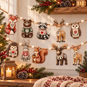 May include: A decorative garland featuring nine individual woodland animal ornaments strung on a thick rope with white wooden beads. The figures include a fox, bear, raccoon, deer, owl, hedgehog, rabbit, squirrel, and moose, all with festive patterns.