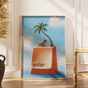 May include: A framed art print featuring a surreal illustration of a person relaxing in a lounge chair on top of a large, tan computer keyboard key labelled with the word enter, accompanied by a palm tree against a blue sky with clouds.
