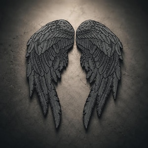 May include: A pair of dark charcoal gray embroidered patches shaped like detailed bird wings. Each patch features intricate stitching to define individual feathers, with a textured surface and a symmetrical design that mirrors the other wing.