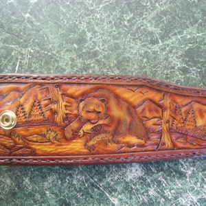 Custom made Bowie knife sheath with trout andMountain scene. Can be personalized.