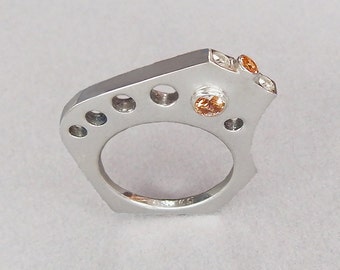 Modern diamond and topaz ring