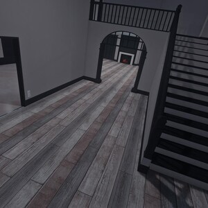 Op de afbeelding: Een interieur met lichtgrijze muren en zwarte afwerking, een trap met zwarte treden en leuningen, en een vloer met houtlook en afwisselend grijze en bruine planken. Een boogvormige deuropening leidt naar een kamer met een open haard.