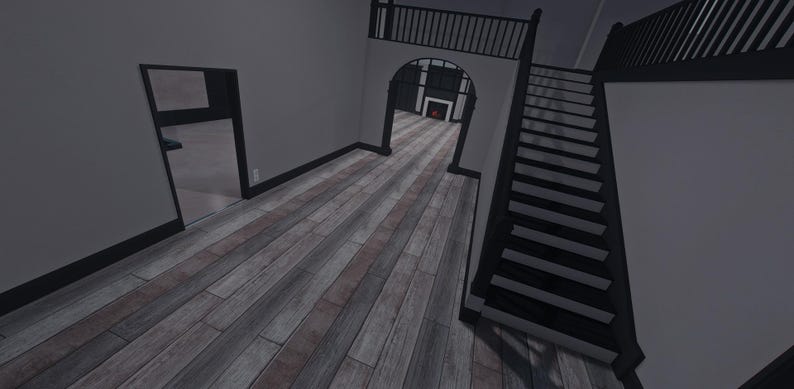 Op de afbeelding: Een interieur met lichtgrijze muren en zwarte afwerking, een trap met zwarte treden en leuningen, en een vloer met houtlook en afwisselend grijze en bruine planken. Een boogvormige deuropening leidt naar een kamer met een open haard.