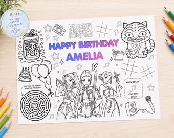 May include: A rectangular coloring sheet featuring the text KPOP DEMON HUNTERS, HAPPY BIRTHDAY AMELIA, and various line art illustrations including three figures, a cat-like creature, a soda can, balloons, a maze, and musical notes.