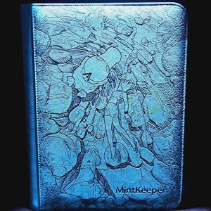 May include: A rectangular blue binder with a textured surface featuring an embossed illustration of a person standing among rocks and a small creature. The word MintKeeper is embossed in the bottom right corner of the front cover.