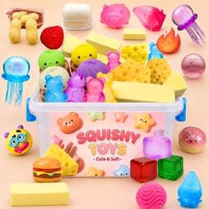 May include: A clear plastic storage bin labeled SQUISHY TOYS Cute & Soft filled with various colorful squishy items including gummy bears, cheese wedges, jellyfish, fruits, and geometric shapes, surrounded by additional loose squishy figures.