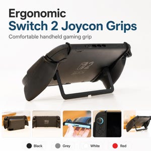 May include: Black ergonomic grips for a handheld gaming console, featuring a kickstand on the back. The text reads: Ergonomic Switch 2 Joycon Grips, Comfortable handheld gaming grip. Includes color options for black, grey, white, and red.