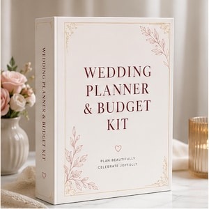 May include: A white wedding planner and budget kit binder with dark red text reading Wedding Planner & Budget Kit and Plan Beautifully Celebrate Joyfully. The cover features gold line art of leaves and a small heart icon on the front and spine.