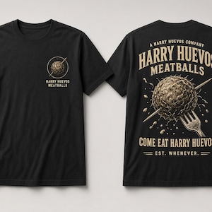 May include: A black short-sleeve t-shirt featuring a small graphic on the front left chest and a large graphic on the back. The front shows a meatball with a fork and the text Harry Huevos Meatballs. The back features a larger version of the meatball with a fork, the text A Harry Huevos Company, Harry Huevos Meatballs, Come Eat Harry Huevos, and Est. Whenever.