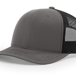 May include: A gray and black trucker hat with a mesh back. The hat has a curved brim and a structured crown.