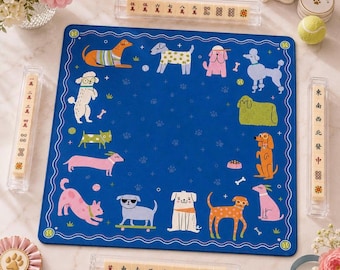 May include: A square blue mahjong mat featuring a border of various colorful illustrated dogs, including poodles, dachshunds, and dogs on skateboards, surrounded by four clear acrylic tile racks containing mahjong tiles with Chinese characters.