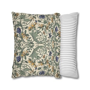 Two square pillows are displayed side by side, one showing the front botanical vine print and the other showing a gray and white striped back.