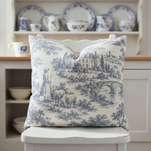 Slate blue pastoral toile de Jouy pillow styled in a French cottage home
