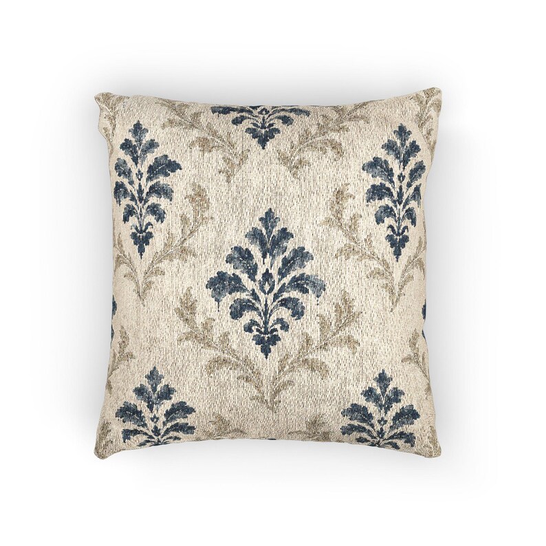 Woven indigo damask tapestry throw pillow on a plain white background, showing blue and tan damask motifs on warm ivory.