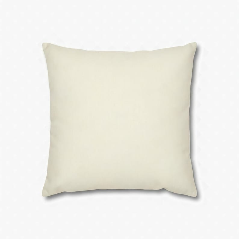 Solid warm ivory square pillow cover on a plain white background