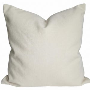 A square, neutral ivory pillow cover shown isolated on a solid white background.