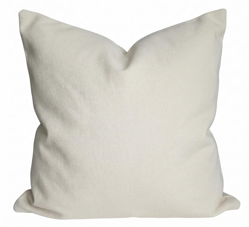 A square, neutral ivory pillow cover shown isolated on a solid white background.