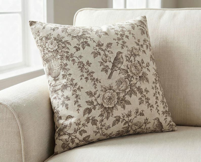 Close-up of the taupe bird and rose toile de Jouy pillow cover showing the songbird and rose print