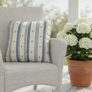 Slate blue fleur de lis ticking stripe pillow styled in a French cottage home