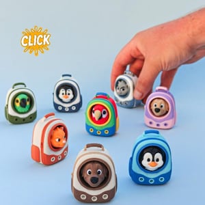 May include: A collection of small, colorful plastic backpack-shaped carriers, each containing a miniature animal figure. The backpacks feature circular viewing windows and ventilation holes. The word CLICK is printed in yellow with a sunburst graphic.