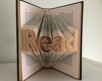 May include: A book with the word "HOPE" folded into the pages. The book is open and the pages are folded to create a 3D effect.
