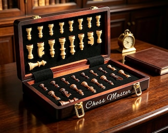 May include: A dark wood chess set in a hinged storage case with the text Chess Master engraved on the front. The interior features black velvet lining with individual slots for light and dark wooden chess pieces, including pawns and major pieces.