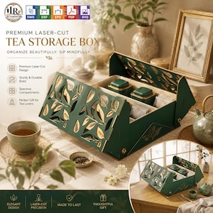 May include: A dark green tea storage box featuring a laser-cut leaf pattern with gold accents. The box has a hinged lid and multiple internal compartments containing two small square tea canisters and several tea bags, with a tea cup nearby.