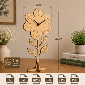May include: A light brown wooden flower-shaped clock with black hands, measuring 17cm wide and 37cm tall with a 3mm wood thickness. The clock features a stem with four leaves and a cross-shaped base. Icons for AI, SVG, DWG, DXF, EPS, and PDF files are visible.