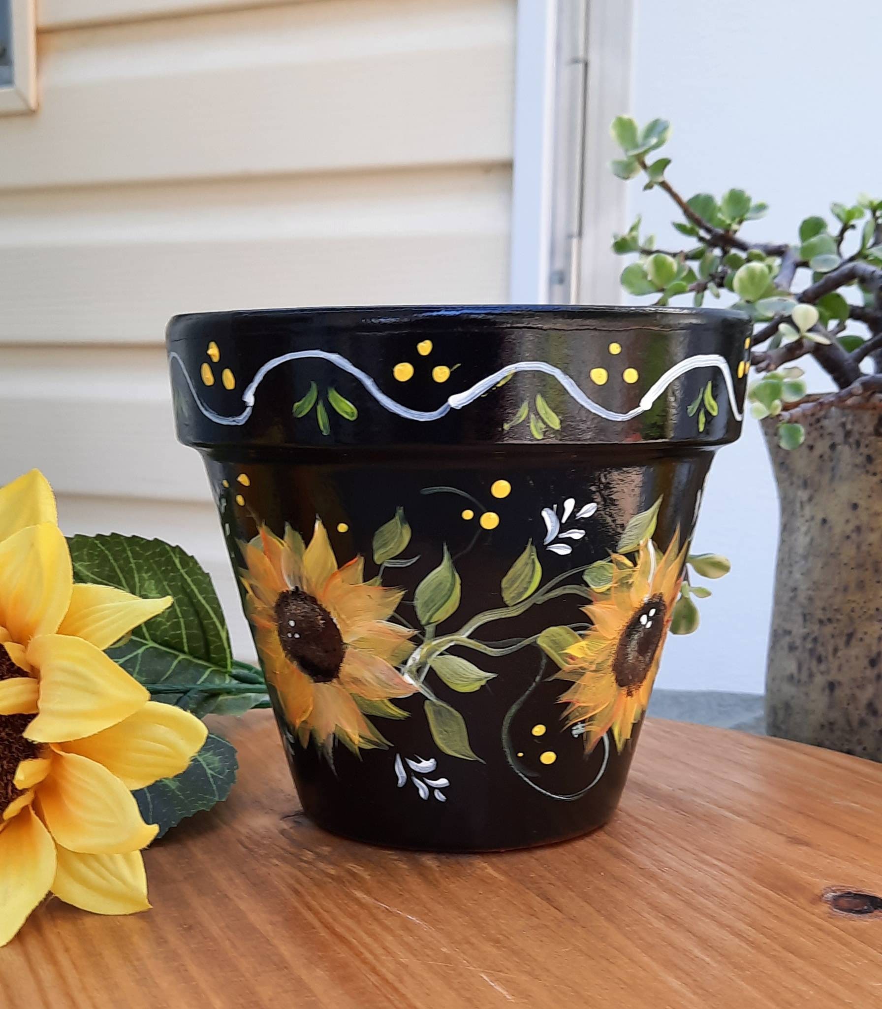 Image of Terracotta ceramic planter with hand-painted design of flowers