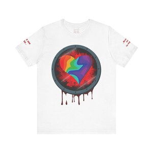 May include: A white t-shirt featuring a central circular porthole graphic containing a rainbow-colored heart. The porthole has a dark grey frame with rivets and red liquid dripping from the bottom. Text on the sleeves reads "...trust me right..." and "...Breathe was to my..."
