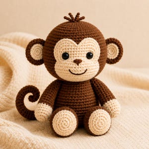 May include: A crocheted monkey toy made with dark brown yarn for the body, head, arms, and legs, featuring light beige yarn for the face, ears, hands, and feet. The monkey has black plastic eyes, a stitched nose, and a curved tail.