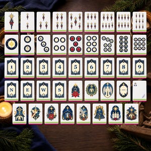 May include: A set of rectangular mahjong tiles featuring Christmas-themed illustrations, including nativity scenes, stars, angels, poinsettias, and numbered tiles from one to nine, alongside tiles marked with the letters N, E, W, S and the word Joker.