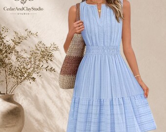 May include: A light blue sleeveless dress with a V-neckline, a gathered elastic waist, and a tiered skirt featuring a subtle textured pattern. The dress is paired with a woven brown and tan tote bag. The text CedarAndClayStudio is visible.