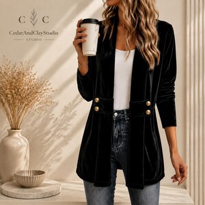 Women’s polyester velvet cardigan in ivory with decorative gold buttons, long sleeves, and a mid-length elegant design.