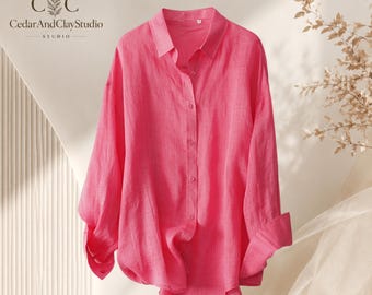 May include: A bright pink long-sleeved button-down shirt with a classic collar and cuffed sleeves. The shirt features a front button placket with matching pink buttons and a textured fabric finish. The CedarAndClayStudio logo is visible.