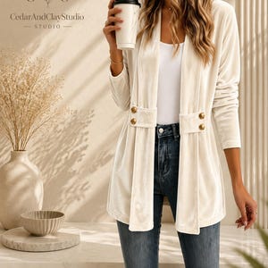 Women’s polyester velvet cardigan in ivory with decorative gold buttons, long sleeves, and a mid-length elegant design.