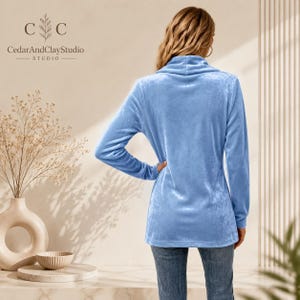 Women’s polyester velvet cardigan in ivory with decorative gold buttons, long sleeves, and a mid-length elegant design.