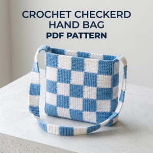 May include: A crochet handbag featuring a blue and white checkered pattern with a matching shoulder strap. The text CROCHET CHECKERD HAND BAG PDF PATTERN is displayed above the bag in dark blue capital letters against a light background.